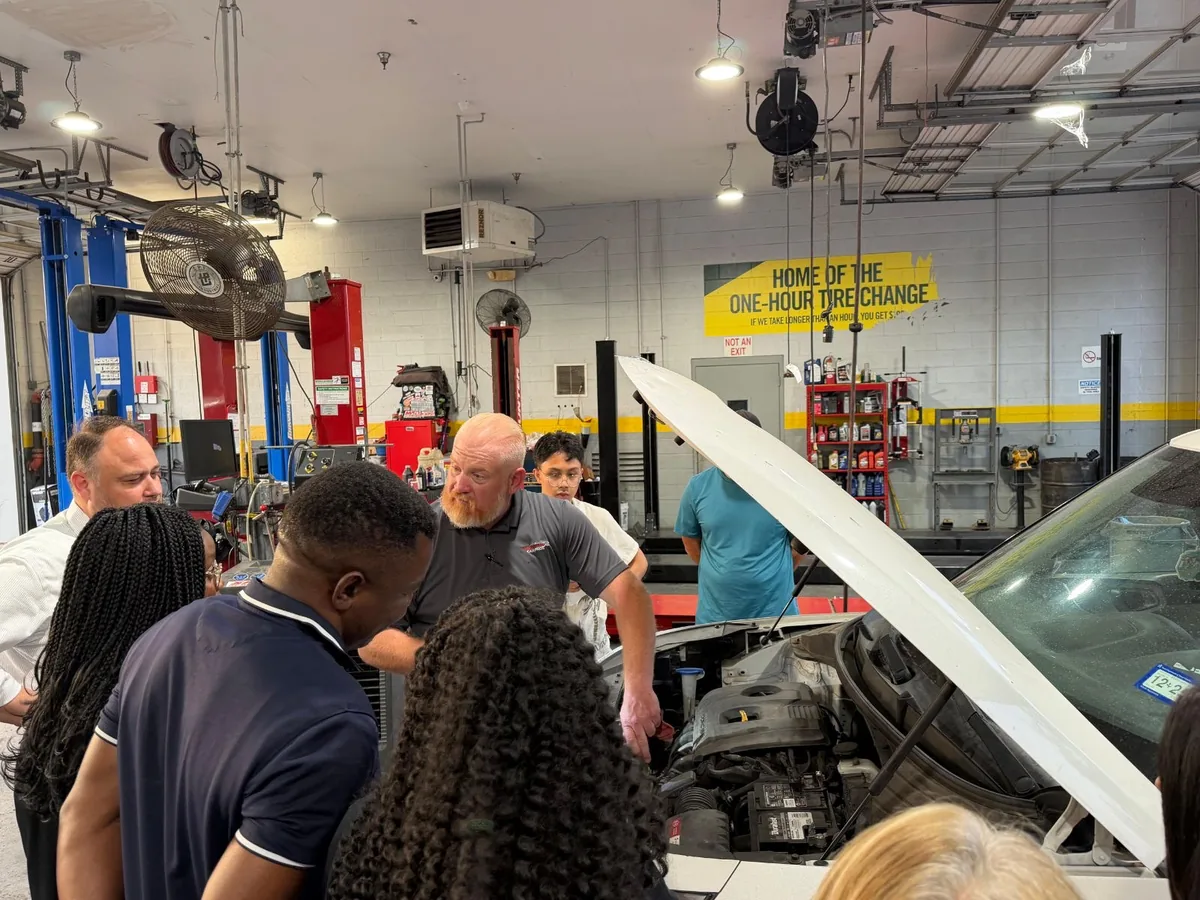 An Integrity 1st team member explaining engine components to Auto Care 101 attendees