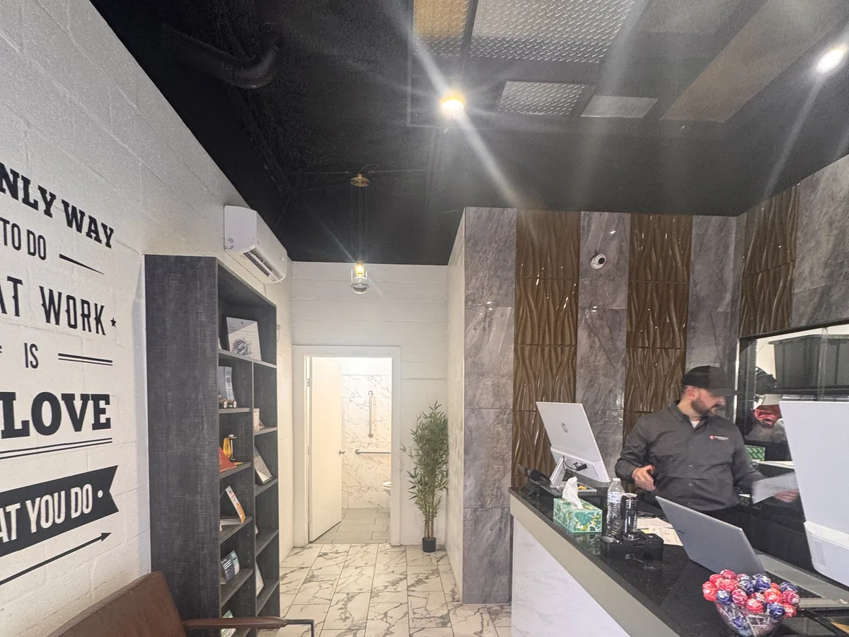Reception at an Integrity 1st location, with wall text reading The only way to do great work is love what you do